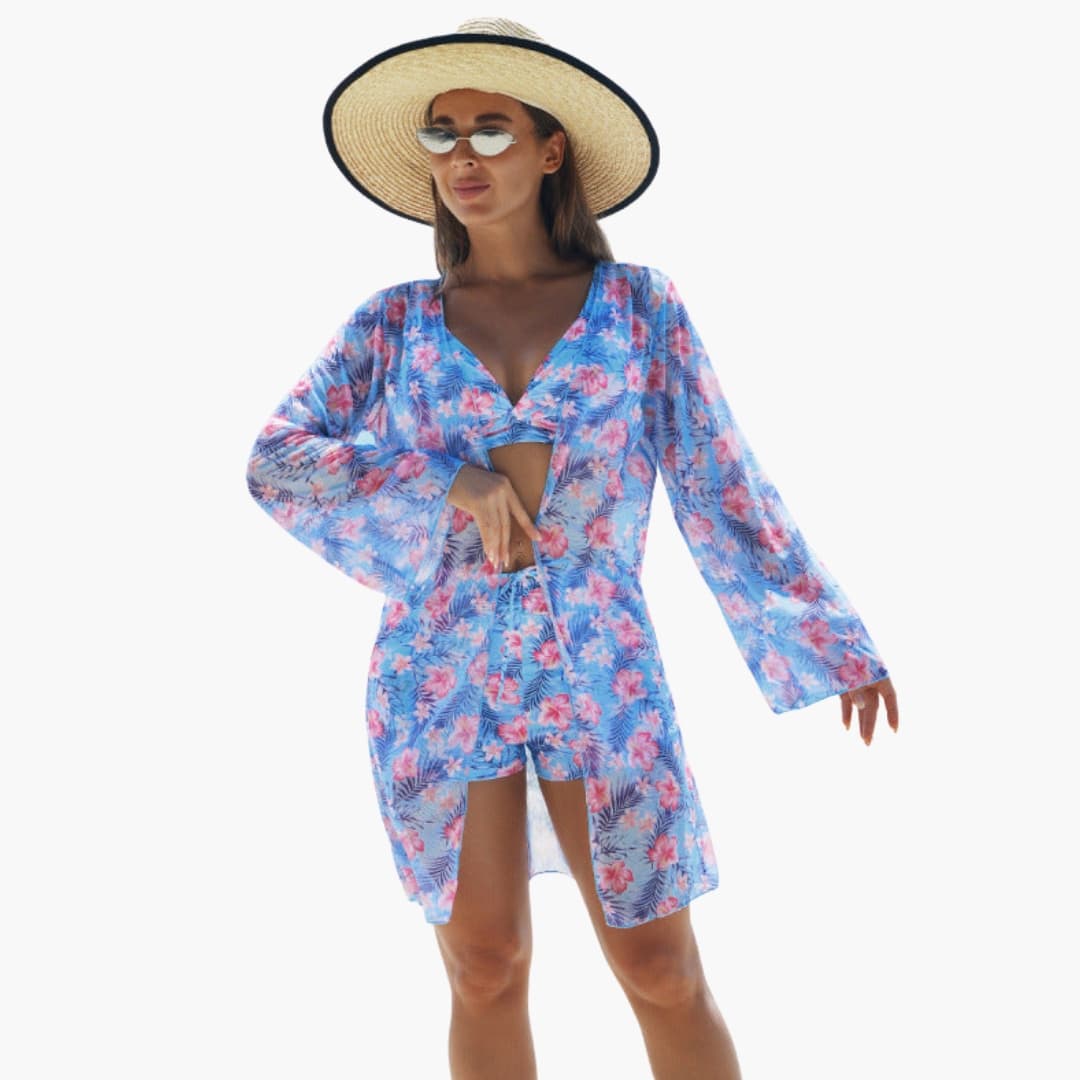 Women's three-piece bikini set with padded top in blue floral print, model wearing matching cover-up