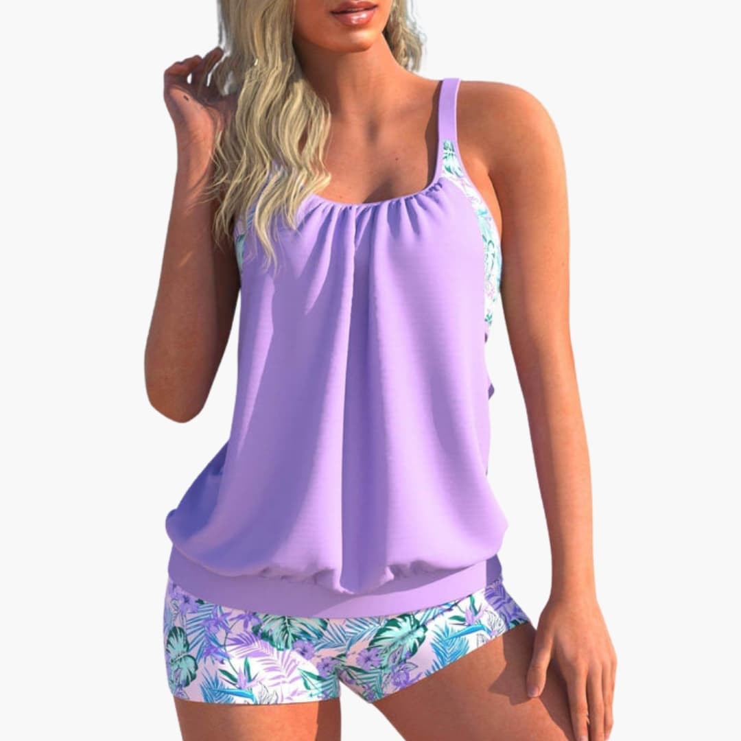 Women’s Tankini Set by Wilfred Smith with lavender top and tropical-print bottoms.