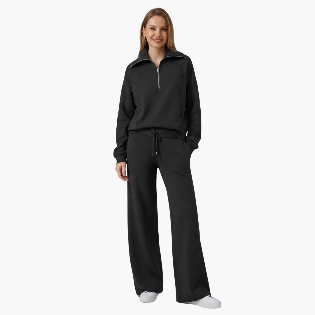 Women's lounge set with half-zip top and wide-leg pants in black with a drawstring waist.