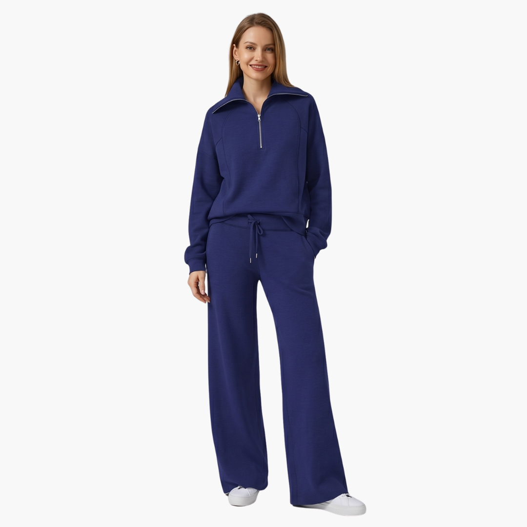 Women's navy blue two-piece lounge set with half-zip top and wide-leg pants
