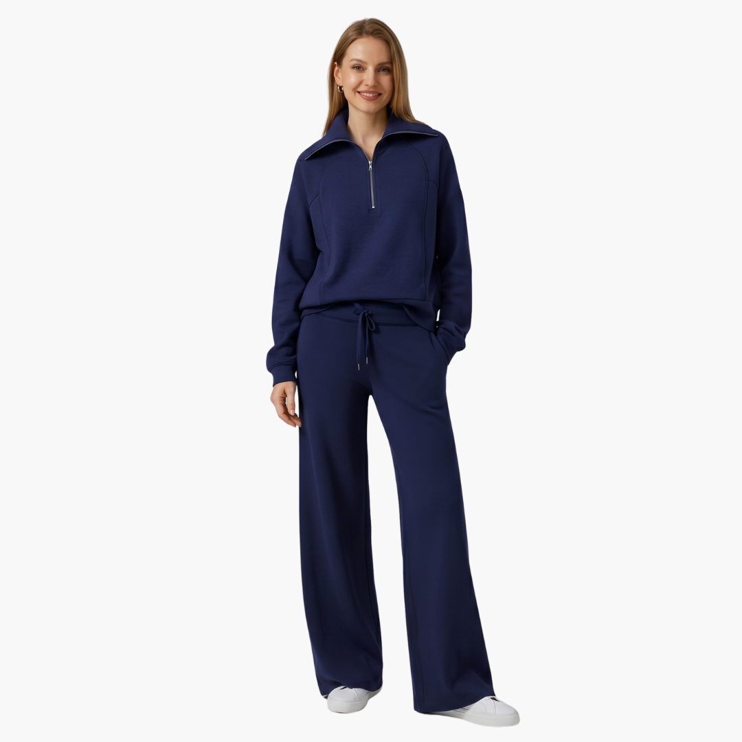 Women's lounge set in navy blue with half-zip top and wide-leg pants by Wilfred Smith.